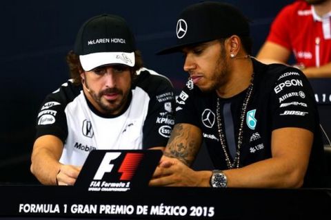 MEXICO CITY, MEXICO - OCTOBER 29:  Fernando Alonso of Spain and McLaren Honda speaks with Lewis Hamilton of Great Britain and Mercedes GP on at a press conference during previews to the Formula One Grand Prix of Mexico at Autodromo Hermanos Rodriguez on October 29, 2015 in Mexico City, Mexico.  (Photo by Clive Mason/Getty Images)