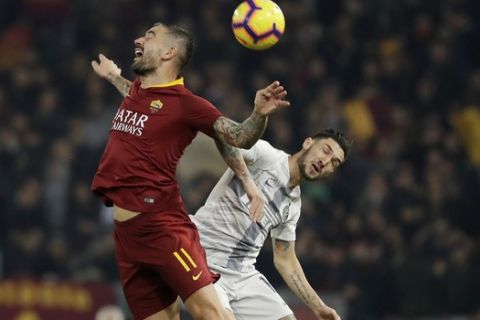 Roma's Aleksandar Kolarov, left, jumps for the ball with Inter Milan's Matteo Politano during the Serie A soccer match between Roma and Inter Milan at the Rome Olympic stadium, Sunday, Dec. 2, 2018. (AP Photo/Andrew Medichini)