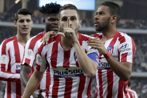 Atletico Madrid's Koke celebrates his goal with teammates during the Spanish Super Cup semifinal soccer match between Barcelona and Atletico Madrid at King Abdullah stadium in Jiddah, Saudi Arabia, Thursday, Jan. 9, 2020. (AP Photo/Hassan Ammar)