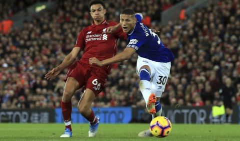 Liverpool defender Trent Alexander-Arnold, left, and Everton forward Richarlison reaches for the ball during the English Premier League soccer match between Liverpool and Everton at Anfield Stadium in Liverpool, England, Sunday, Dec. 2, 2018. (AP Photo/Jon Super)