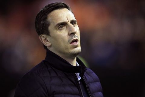 FILE - In this Sunday, Jan. 3, 2016 file photo, Valencia's head coach Gary Neville arrives for a Spanish La Liga soccer match against Real Madrid at the Mestalla stadium in Valencia, Spain. Gary Neville knew that coaching at a high level wasnt going to be easy. He certainly didnt expect to be struggling so badly so early. Less than two months into his first head-coaching job, the former England great is already in danger of being fired. Publicly, the club is backing up Neville despite the disappointing results and the increased pressure from supporters unsatisfied with the coach. "Gary arrived when we were going through a difficult situation," Valencia's sporting director Jesus Garcia Pitarch said Monday, Feb. 1, 2016. "We know he can overcome this situation. We have to be patient." (AP Photo/Alberto Saiz, File)