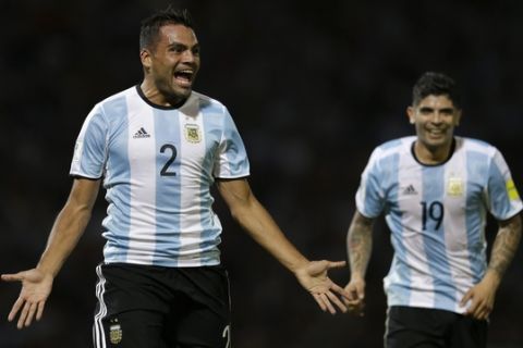 Argentina's Gabriel Mercado, left, followed by Argentina's Ever Banega, celebrates scoring against  Bolivia during a 2018 World Cup qualifying soccer match in Cordoba, Argentina, Tuesday, March 29, 2016.(AP Photo/Natacha Pisarenko)