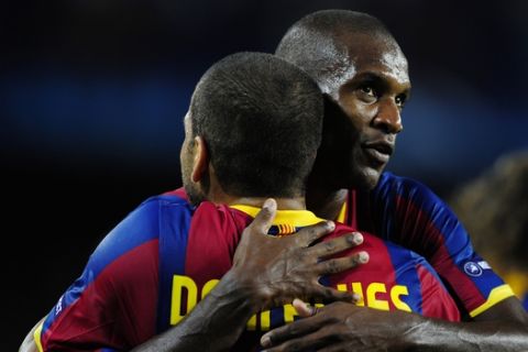 FC Barcelona's Daniel Alves from Brazil is congratulated by his teammate Eric Abidal from France after scoring against Panathinaikos during a Group D Champions League first leg soccer match at the Camp Nou stadium in Barcelona, Spain, Tuesday, Sept. 14, 2010. (AP Photo/Manu Fernandez)