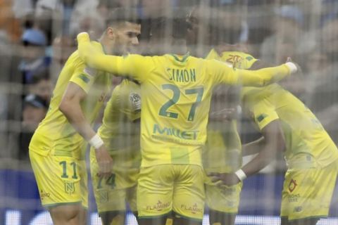 Nantes' players celebrates after Nantes' Anthony Limbombe scored his side's opening goal during the French League One soccer match between Marseille and Nantes at the Stade Velodrome in Marseille, southern France, Sunday Feb. 22, 2020. (AP Photo/Daniel Cole)