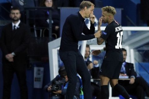 PSG forward Neymar, right, talks to PSG coach Thomas Tuchel after he was replaced by PSG forward Julian Draxler during the group C Champions League soccer match between Paris Saint Germain and Red Star Belgrade at the Parc des Princes stadium in Paris, France, Wednesday, Oct. 3, 2018. (AP Photo/Francois Mori)