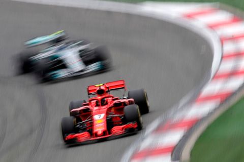 Ferrari driver Kimi Raikkonen of Finland steers his car followed by Mercedes driver Valtteri Bottas of Finland during the second practice session for the Chinese Formula One Grand Prix at the Shanghai International Circuit in Shanghai, Friday, April 13, 2018. (AP Photo/Andy Wong)
