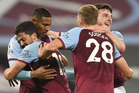 West Ham's Sebastien Haller, second left, is congratulated by teammates after scoring his team's fourth goal during the English Premier League soccer match between West Ham and Wolverhampton Wanderers at London Stadium, London, England, Sunday, Sept. 27, 2020. (Andy Rain/Pool via AP)