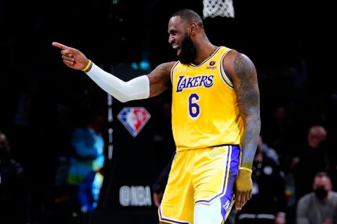 Los Angeles Lakers' LeBron James (6) gestures to fans after dunking the ball during the second half of an NBA basketball game against the Brooklyn Nets Tuesday, Jan. 25, 2022 in New York. The Lakers won 106-96. (AP Photo/Frank Franklin II)