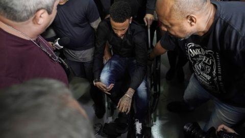 Brazilian soccer player Neymar arrives to a police station, in a wheelchair due to an ankle injury, in Rio de Janeiro, Brazil, Thursday, June 6, 2019. Rio de Janeiro police said Thursday that soccer star Neymar was expected to testify soon in an investigation linked to a woman's rape allegation against him. (AP Photo/Leo Correa)