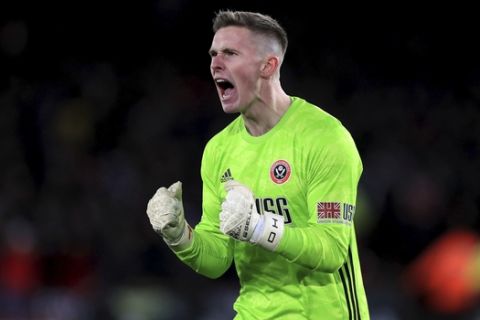Sheffield United goalkeeper Dean Henderson celebrates his side's second goal, during the English Premier League soccer match between Sheffield United and Aston Villa, at Bramall Lane, in Sheffield, England, Saturday, Dec. 14, 2019. (Mike Egerton/PA via AP)
