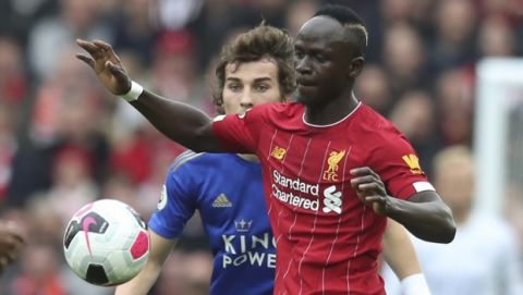 Liverpool's Sadio Mane, vies for the ball with Leicester City's Caglar Soyuncu during English Premier League soccer match between Liverpool and Leicester City in Anfield stadium in Liverpool, England, Saturday, Oct. 5, 2019. (AP Photo/Jon Super)