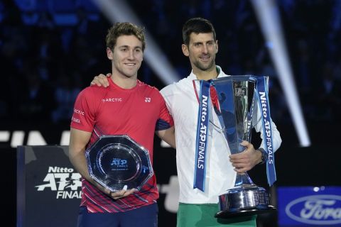 Serbia's Novak Djokovic and Norway's Casper Ruud, right, poses with their trophies after the singles final tennis match of the ATP World Tour Finals at the Pala Alpitour, in Turin, Italy, Sunday, Nov. 20, 2022. Djokovic defeated Ruud 7-5, 6-3. (AP Photo/Antonio Calanni)
