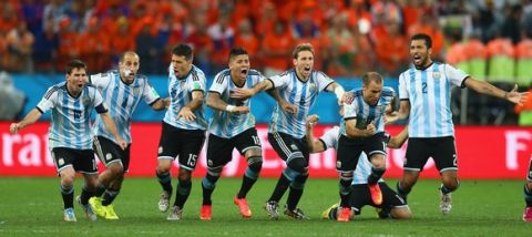 SAO PAULO, BRAZIL - JULY 09:  Lionel Messi, Pablo Zabaleta, Martin Demichelis, Marcos Rojo, Lucas Biglia, Javier Mascherano, Rodrigo Palacio and Ezequiel Garay of Argentina celebrate defeating the Netherlands in a shootout during the 2014 FIFA World Cup Brazil Semi Final match between the Netherlands and Argentina at Arena de Sao Paulo on July 9, 2014 in Sao Paulo, Brazil.  (Photo by Ronald Martinez/Getty Images)