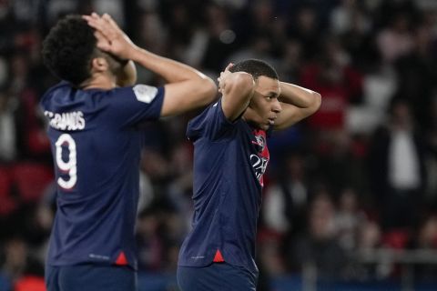 PSG's Kylian Mbappe, center, and Goncalo Ramos react during the French League One soccer match between Paris Saint-Germain and Clermont at the Parc des Princes stadium in Paris, Saturday, April 6, 2024. (AP Photo/Lewis Joly)