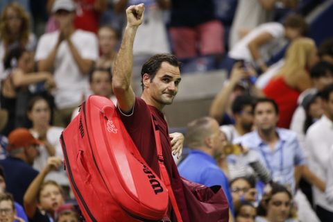 Roger Federer, of Switzerland, waves to the crowd as he leaves the court after losing to John Millman, of Australia, during the fourth round of the U.S. Open tennis tournament early Tuesday, Sept. 4, 2018, in New York. (AP Photo/Jason DeCrow)