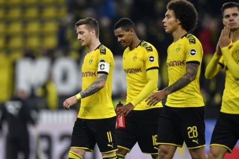 Dortmund's Marco Reus, Manuel Akanji, Axel Witsel and Julian Weigl, from left, leave the pitch after the German Bundesliga soccer match between Borussia Dortmund and Borussia Moenchengladbach in Dortmund, Germany, Saturday Oct. 19, 2019. (AP Photo/Martin Meissner)