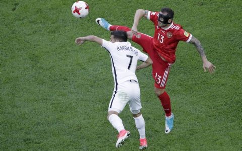 New Zealand's Kosta Barbarouses, left, vies for the ball with Russia's Fedor Kudriashovduring the Confederations, Cup Group A soccer match between Russia and New Zealand, at the St.Petersburg stadium in St.Petersburg, Russia, Saturday, June 17, 2017. (AP Photo/Dmitri Lovetsky)