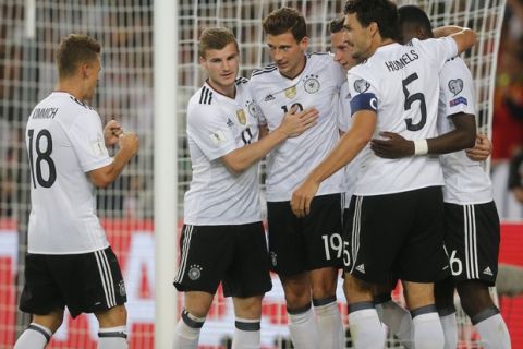 Germany's Leon Goretzka, center, celebrates with his teammates after scoring his side's fifth goal during the World Cup Group C qualifying soccer match between Germany and Norway in Stuttgart, Germany, Monday, Sept. 4, 2017. (AP Photo/Michael Probst)