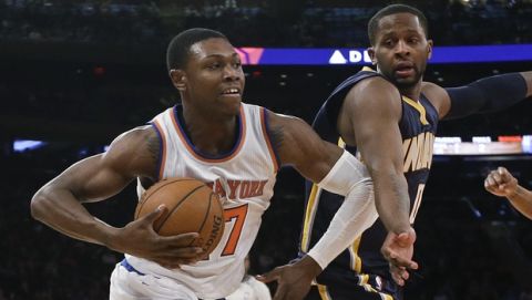 New York Knicks' Cleanthony Early (17) drives past Indiana Pacers' C.J. Miles and David West (21) during the first half of an NBA basketball game Saturday, March 7, 2015, in New York. (AP Photo/Frank Franklin II)