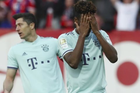 Bayern's Kingsley Coman, right, reacts after missing a scoring chance during the German Bundesliga soccer match between 1. FC Nuremberg and FC Bayern Munich in Nuremberg, Germany, Sunday, April 28, 2019. (AP Photo/Matthias Schrader)