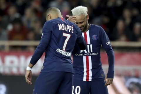 PSG's Neymar, right, celebrates with PSG's Kylian Mbappe after scoring his side's second goal during the French League One soccer match between Monaco and Paris Saint-Germain at the Louis II stadium in Monaco, Wednesday, Jan. 15, 2019. (AP Photo/Daniel Cole)