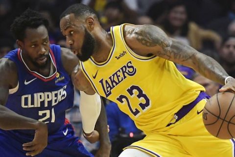 Los Angeles Lakers forward LeBron James, right, tries to drive past Los Angeles Clippers guard Patrick Beverley during the first half of an NBA basketball game Thursday, Jan. 31, 2019, in Los Angeles. (AP Photo/Mark J. Terrill)