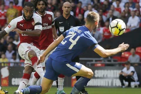 Arsenal'sAlexandre Lacazette, left , shoots on goal during the English Community Shield soccer match between Arsenal and Chelsea at Wembley Stadium in London, Sunday, Aug. 6, 2017. (AP Photo/Frank Augstein)