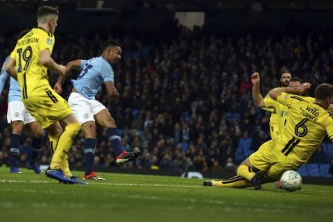 Manchester City forward Gabriel Jesus, second left, scores his side third goal during the English League Cup semi-final first leg soccer match between Manchester City and Burton Albion at the Etihad Stadium in Manchester, England, Wednesday, Jan. 9, 2019. (AP Photo/Dave Thompson)