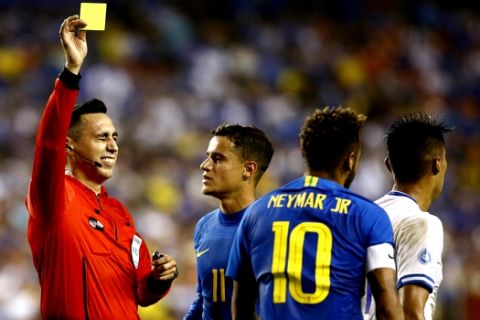 An official gives Brazil forward Neymar (10) a yellow card in the first half of a soccer match between Brazil and El Salvador, Tuesday, Sept. 11, 2018, in Landover, Md. (AP Photo/Patrick Semansky)