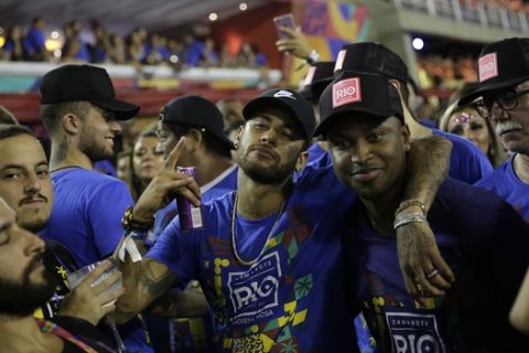 Brazil's soccer player Neymar, center, attends the Carnival celebrations at the Sambadrome in Rio de Janeiro, Brazil, Tuesday, March 5, 2019. (AP Photo/Silvia Izquierdo)