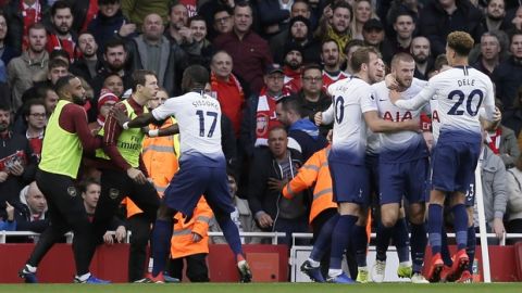 Tottenham's Harry Kane, center, celebrates with his teammates after scoring his side's opening goal from the penalty spot as Tottenham's Moussa Sissoko, third left, agrees with Arsenal's Stephan Lichtsteiner, second left, during the English Premier League soccer match between Arsenal and Tottenham Hotspur at the Emirates Stadium in London, Sunday Dec. 2, 2018. (AP Photo/Tim Ireland)
