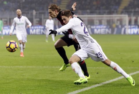 FILE - In this Feb. 19, 2017 file photo, Fiorentina's Federico Chiesa, right, and AC Milan's Ignazio Abate go for the ball during a Serie A soccer match at the San Siro stadium in Milan, Italy. FIFA Under-20 World Cup kicks off in South Korea on Saturday, May 20, 2017. Italy's hopes may rest on the shoulders of Federico Chiesa of Fiorentina who has already established himself in Italy's top tier, Serie A. (AP Photo/Antonio Calanni, File)