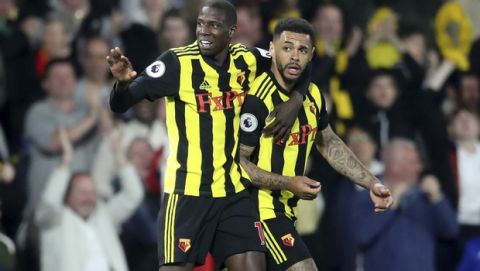 Watford's Andre Gray, right, celebrates scoring his side's first goal of the game against Southampton, during their English Premier League soccer match at Vicarage Road in Watford, London, England, Tuesday April 23, 2019. (Adam Davy/PA via AP)