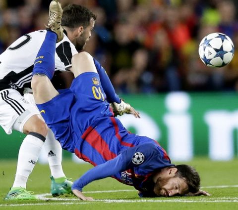 Barcelona's Lionel Messi, right, lands on the pitch after being challenged by Juventus's Miralem Pjanic, left, during the Champions League quarterfinal second leg soccer match between Barcelona and Juventus at Camp Nou stadium in Barcelona, Spain, Wednesday, April 19, 2017. (AP Photo/Manu Fernandez)