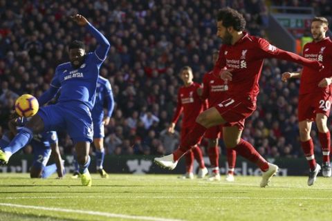 Liverpool's Mohamed Salah scores his side's first goal of the game during the English Premier League soccer match between Liverpool and Cardiff City at Anfield, in Liverpool, England, Saturday, Oct. 27, 2018. (Dave Thompson/PA via AP)