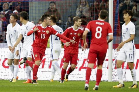 Russia's Fyodor Smolov, third from left, celebrates after scoring a goal during the international friendly soccer match between Russia and South Korea in Moscow, Russia, Saturday, Oct. 7, 2017. (AP Photo/Pavel Golovkin)