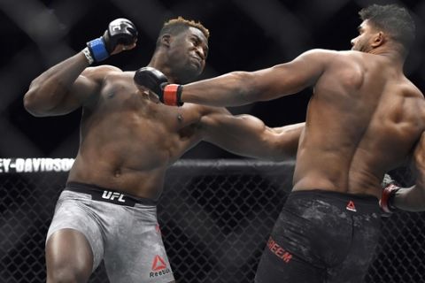 Francis Ngannou, left, hits Alistair Overeem in the first round during a UFC 218 heavyweight mixed martial arts bout, Saturday, Dec. 2, 2017 in Detroit. Ngannou defeated Overeem by first-round knockout. (AP Photo/Jose Juarez)