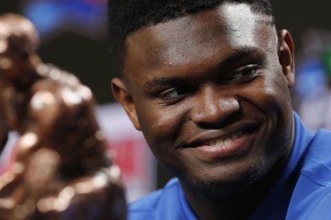 Duke freshman Zion Williamson sits behind the Oscar Robertson Trophy at a news conference where he was awarded the U.S. Basketball Writers Association College Player of the Year award at the Final Four NCAA college basketball tournament, Friday, April 5, 2019, in Minneapolis. (AP Photo/Charlie Neibergall)