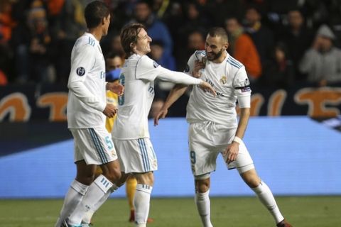 Real Madrid's Karim Benzema, right, celebrates after scoring the second goal of his team with Luka Modric, center, during the Champions League Group H soccer match between APOEL Nicosia and Real Madrid at GSP stadium, in Nicosia, on Tuesday, Nov. 21, 2017. (AP Photo/Petros Karadjias)