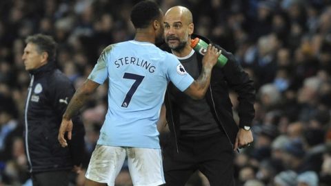 Manchester City's Raheem Sterling, left, and Manchester City manager Josep Guardiola during the English Premier League soccer match between Manchester City and Leicester City at the Etihad Stadium in Manchester, England, Saturday, Feb. 10, 2018. (AP Photo/Rui Vieira)
