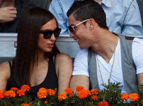 MADRID, SPAIN - MAY 10:  Real Madrid player Cristiano Ronaldo (R) cuddles with his girlfriend Irina Shayk during the match between Rafael Nadal and David Ferrer of Spain on day seven of the Mutua Madrid Open tennis tournament at the Caja Magica  on May 10, 2013 in Madrid, Spain.  (Photo by Jasper Juinen/Getty Images)
