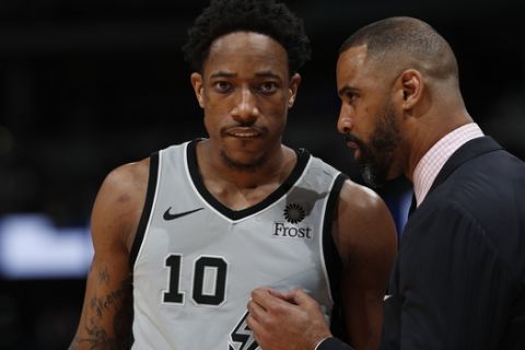 San Antonio Spurs guard DeMar DeRozan (10) confers with assistant coach Ime Udoka in the first half of Game 1 of an NBA first-round basketball playoff series Saturday, April 13, 2019, in Denver. (AP Photo/David Zalubowski)