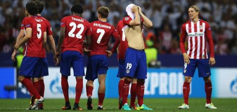 MILAN, ITALY - MAY 28:  Atletico Madrid players show their dejection after their defeat through the penalty shootout in the UEFA Champions League Final between Real Madrid and Club Atletico de Madrid at Stadio Giuseppe Meazza on May 28, 2016 in Milan, Italy..  (Photo by Steve Bardens - UEFA/UEFA via Getty Images)