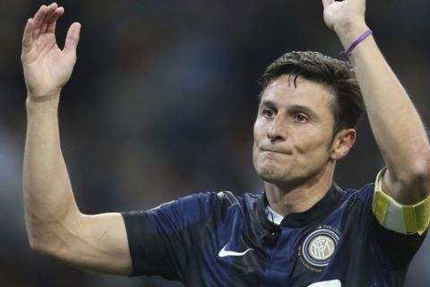 Inter Milan's Javier Zanetti,of Argentina greets his fans  at the end of the Serie A soccer match between Inter Milan and Lazio at the San Siro stadium in Milan, Italy, Saturday, May 10, 2014. Zanetti will retire after 19 seasons at Inter, and the stadium was sold out as fans packed in to bid farewell to their 40-year-old captain. (AP Photo/Antonio Calanni)
