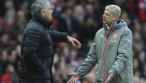 Arsenal manager Arsene Wenger, right, reacts along side Manchester United manager Jose Mourinho during the English Premier League soccer match between Manchester United and Arsenal at Old Trafford in Manchester, England, Saturday, Nov. 19, 2016. (AP Photo/Rui Vieira)