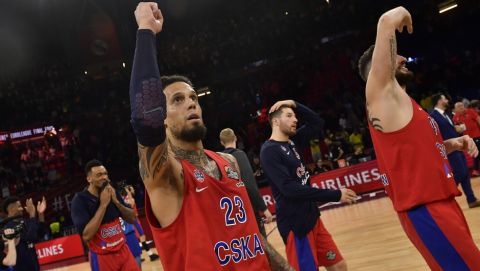 Moscow's Daniel Hackett, center, and Moscow's Nikita Kurbanov, right, celebrate their team's 95-90 win in the Euroleague Final Four semifinal basketball match between CSKA Moscow and Real Madrid at the Fernando Buesa Arena in Vitoria, Spain, Friday, May 17, 2019. (AP Photo/Alvaro Barrientos)