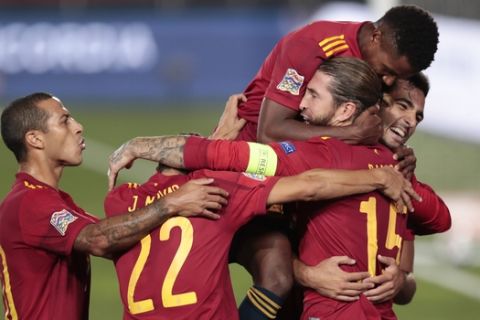 Spain's Sergio Ramos, 15, is congratulated by teammates after scoring his team's second goal during the UEFA Nations League soccer match between Spain and Ukraine at the Estadio Alfredo Di Stefano stadium in Madrid, Spain, Sunday, Sept. 6, 2020. (AP Photo/Bernat Armangue)