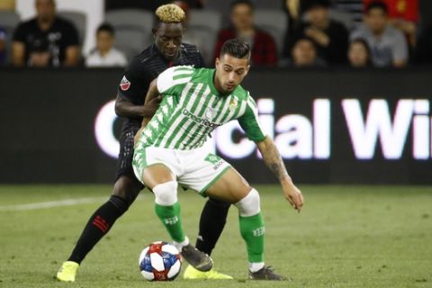 Real Betis forward Sergio Leon, front, guards the ball from D.C. United defender Akeem Ward in the first half of a friendly soccer match, Wednesday, May 22, 2019, in Washington. (AP Photo/Patrick Semansky)