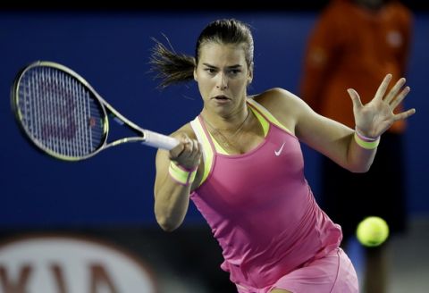 Ajla Tomljanovic of Australia makes a forehand return to Shelby Rogers of the U.S. in their first round match at the Australian Open tennis championship in Melbourne, Australia, Tuesday, Jan. 20, 2015. (AP Photo/Lee Jin-man)