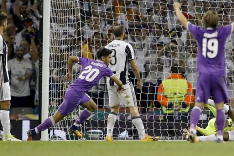 Real Madrid's Marco Asensio, 20, scores the fourth goal during the Champions League final soccer match between Juventus and Real Madrid at the Millennium stadium in Cardiff, Wales Saturday June 3, 2017. (AP Photo/Frank Augstein)